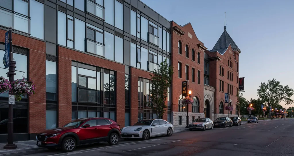 Exterior of Y Lofts building in Peterborough at sunset, with warm lighting highlighting its historic details