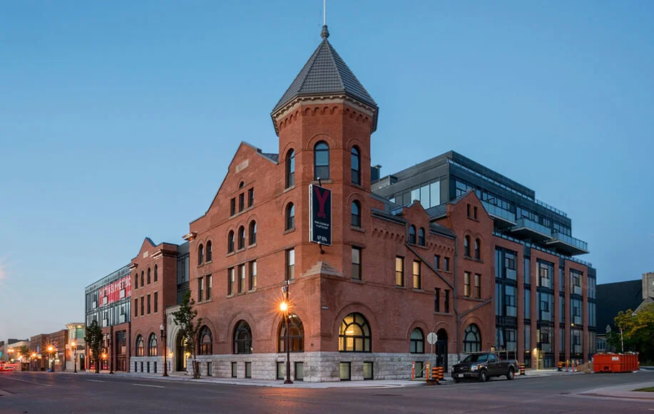 Y Lofts building in Peterborough at dusk, with warm lighting accentuating its historic architecture