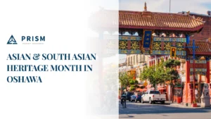 A vibrant street scene with a traditional Asian archway, promoting "Asian & South Asian Heritage Month in Oshawa" alongside a property management logo.