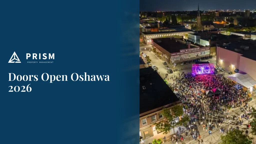 Aerial view of a nighttime street festival for Doors Open Oshawa 2026, featuring a large crowd gathered around a lit stage, presented by Prism Property Management.