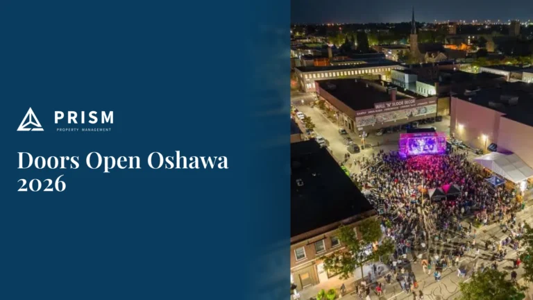 Aerial view of a nighttime street festival for Doors Open Oshawa 2026, featuring a large crowd gathered around a lit stage, presented by Prism Property Management.